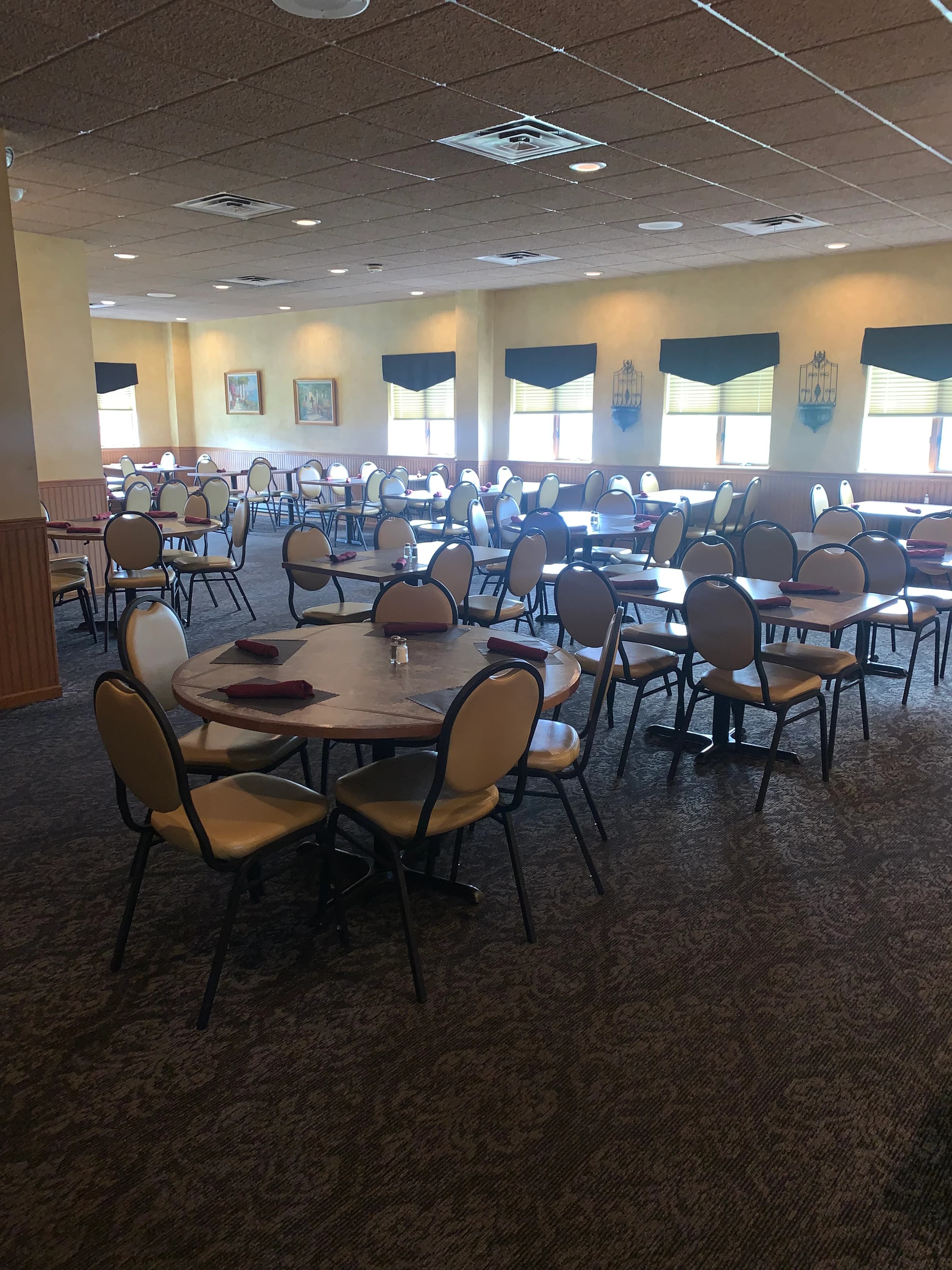 Large banquet room with round tables and chairs