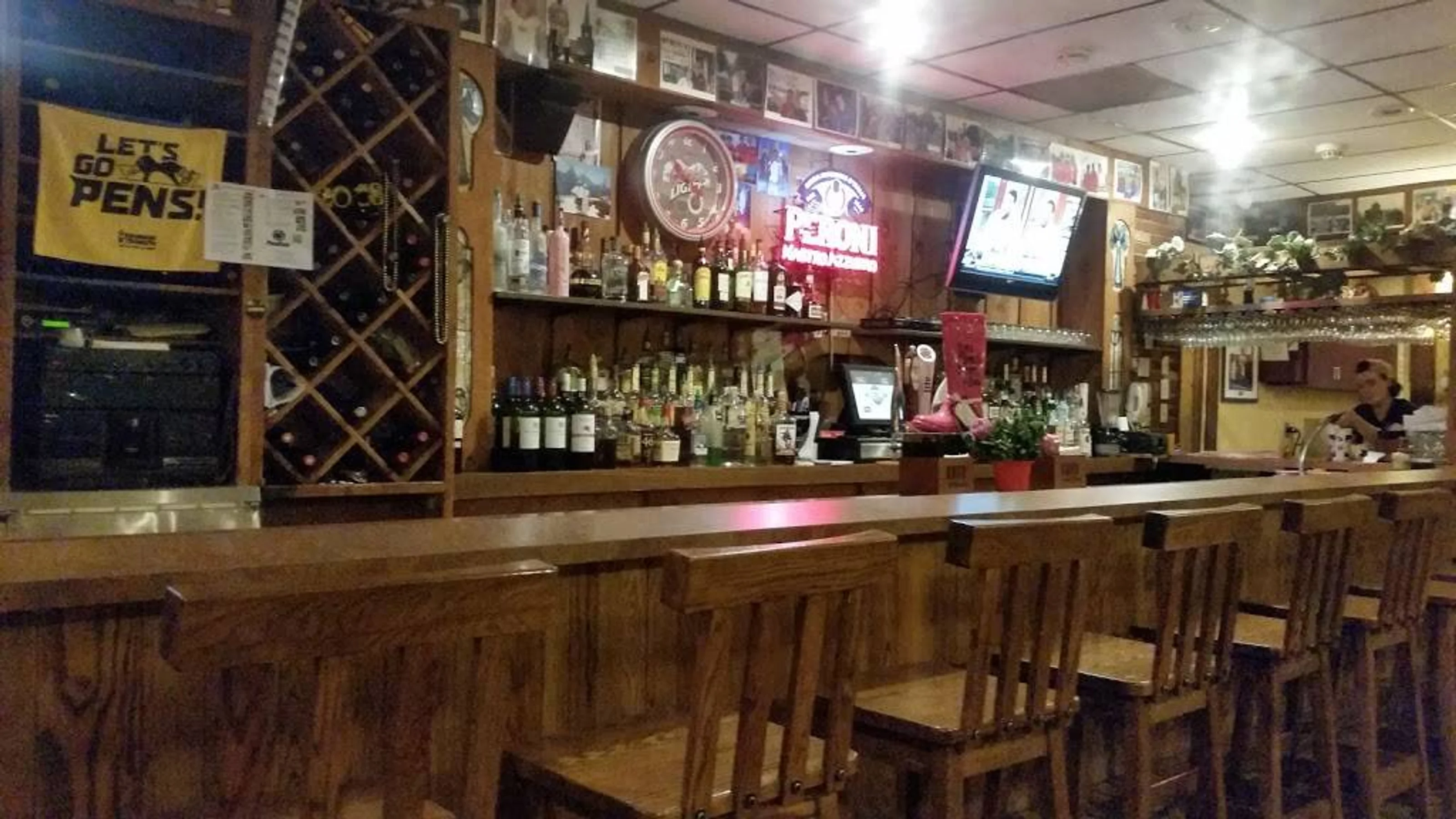 Rizzo's bar area with service staff in the background